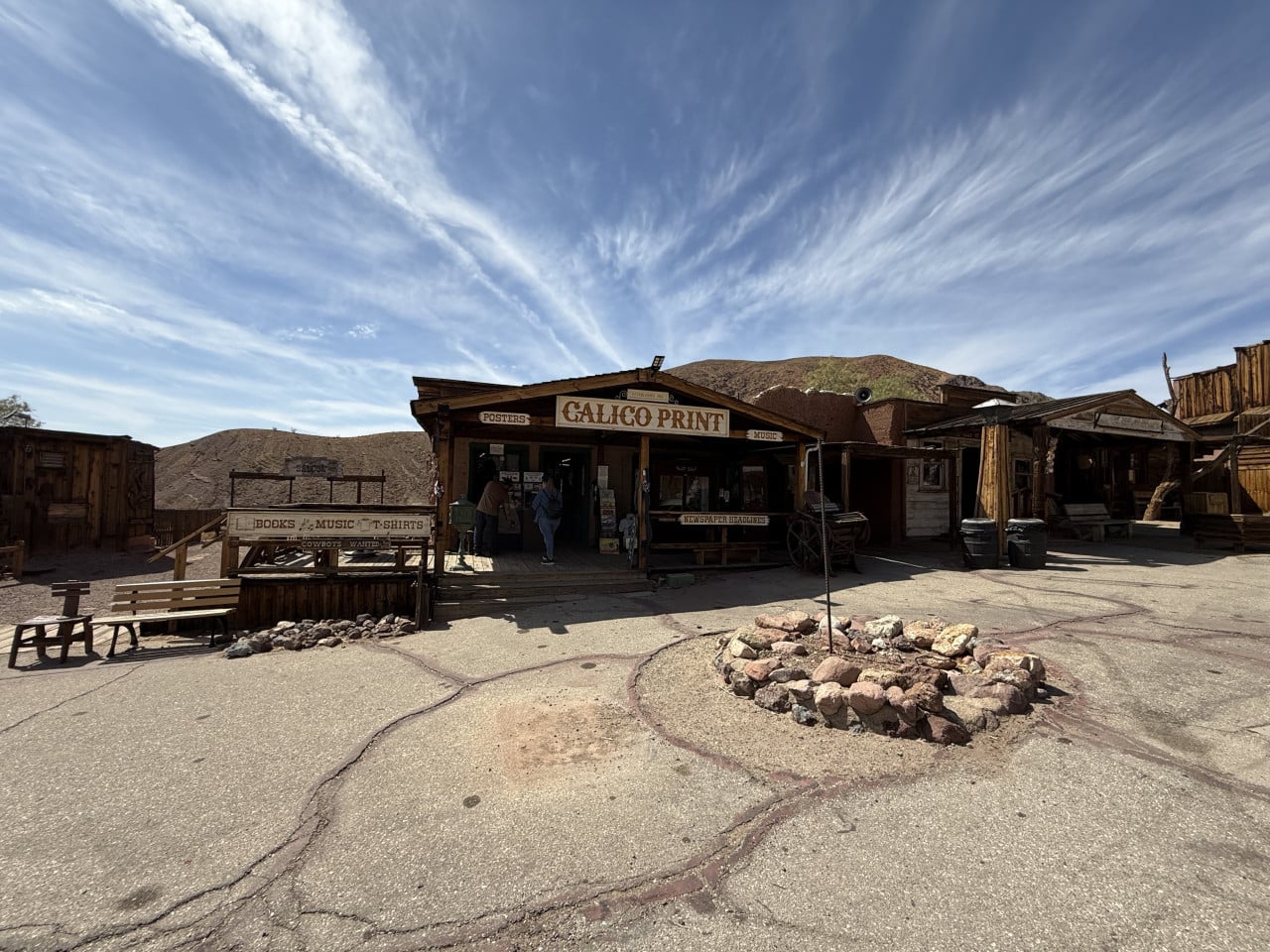 Calico Print ve dřevěné budovy v pouštním ghost townu pod dramatickou oblohou