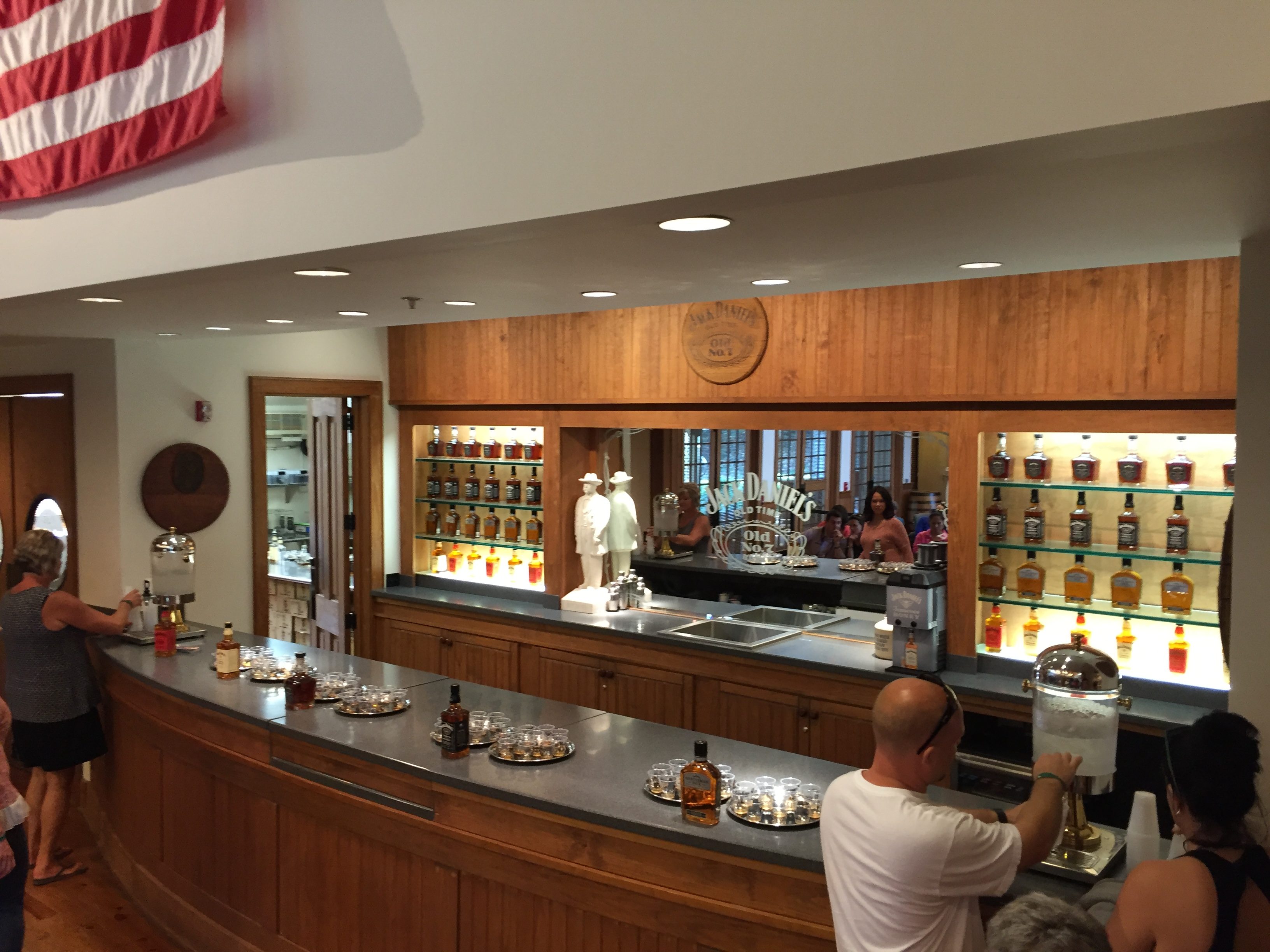 Degustační bar v destilerii Jack Daniel’s, lahve, skleničky, nápis Jack Daniel’s Old No. 7.