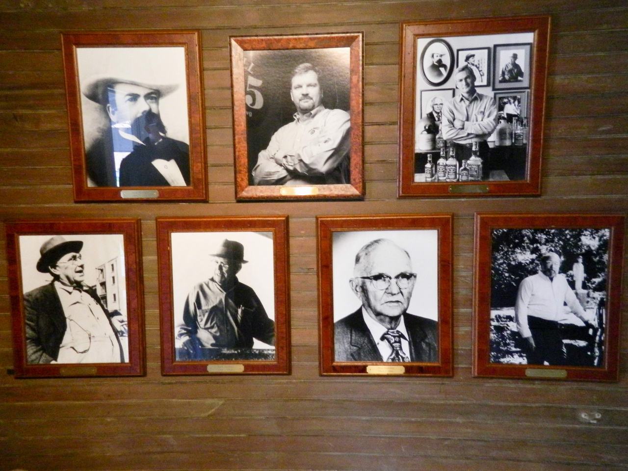 Stěna s šesti zarámovanými černobílými portréty mužů v destilerii Jack Daniel’s.