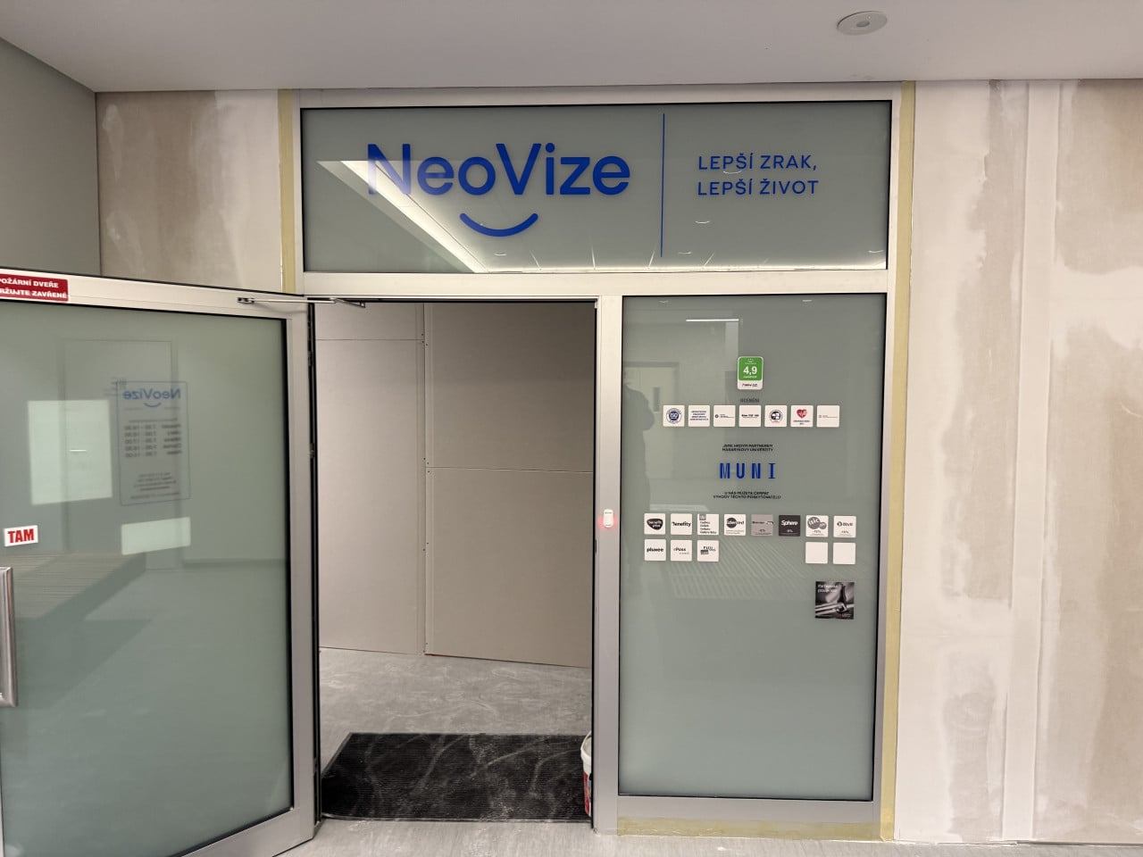 Vstup do oční kliniky NeoVize s logem a sloganem Lepší zrak, lepší život