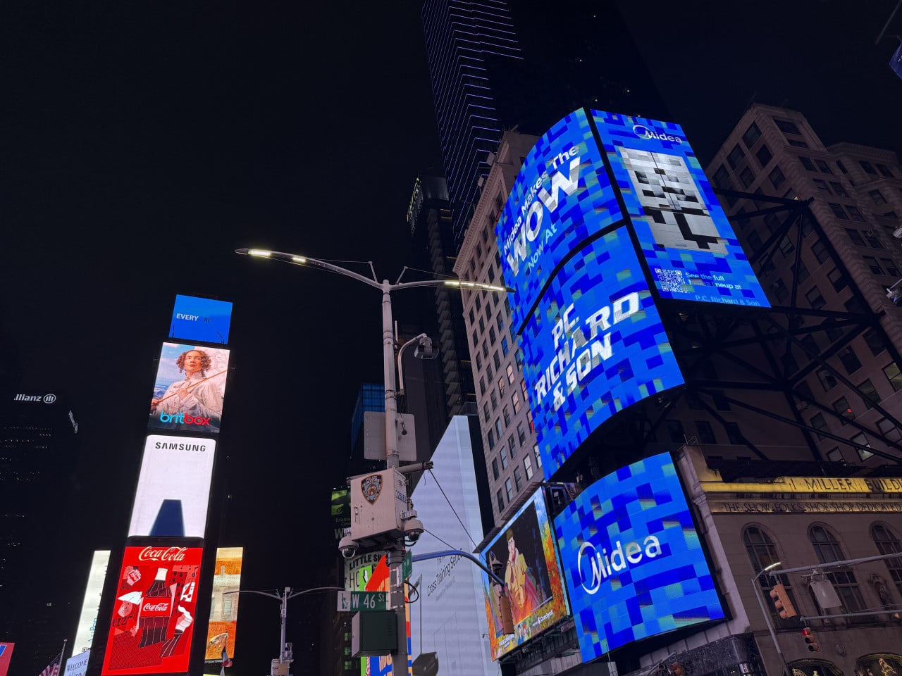 Noční Times Square s obřími světelnými billboardy a křižovatkou W 46 St.