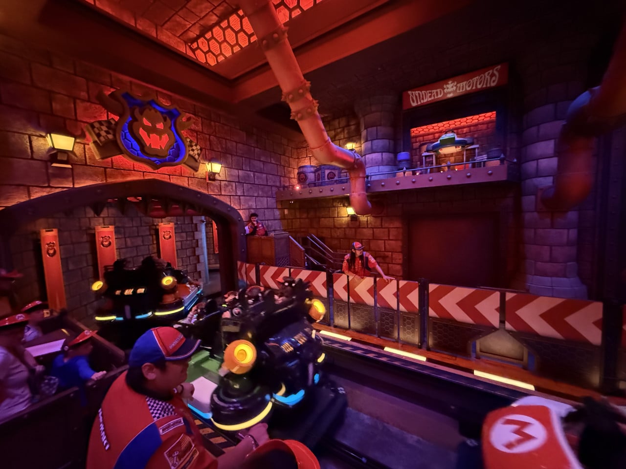 Jízda Mario Kart ve středověkém hradu s logem Bowsera a červeným osvětlením