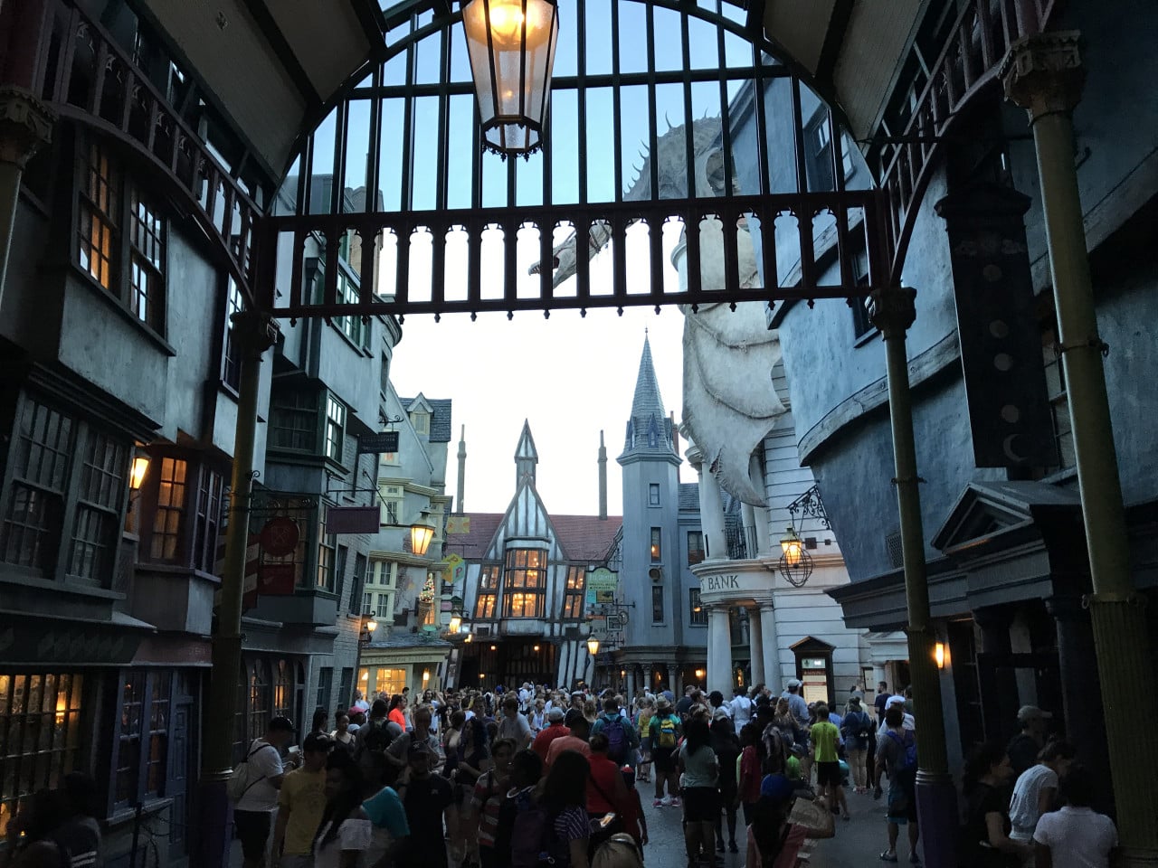 Přeplněná Příčná ulice v Universal Studios, s kulisami banky a věží Bradavic.